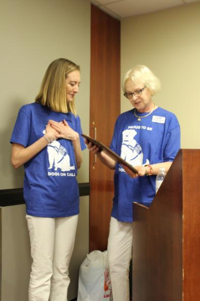 Dr. Sandra Barker, Center Director, presents Rebecca Vokes, Volunteer Coordinator, with an appreciation plaque in recognition of Rebecca's service to The Center