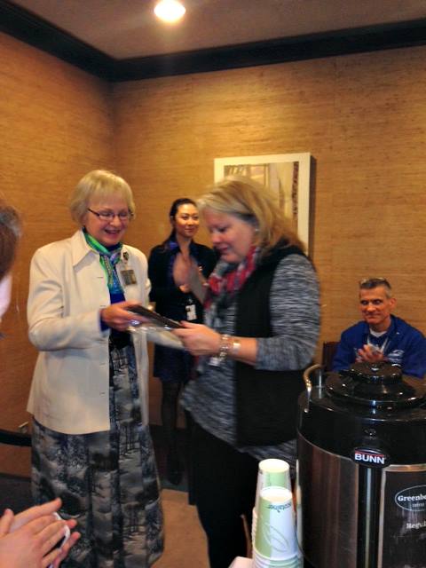 Dr. Sandra Barker presents a recognition plaque to a General Assembly supporter